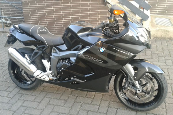 Schwarzes BMW K1300S Motorrad auf einer gepflasterten Oberfläche geparkt.